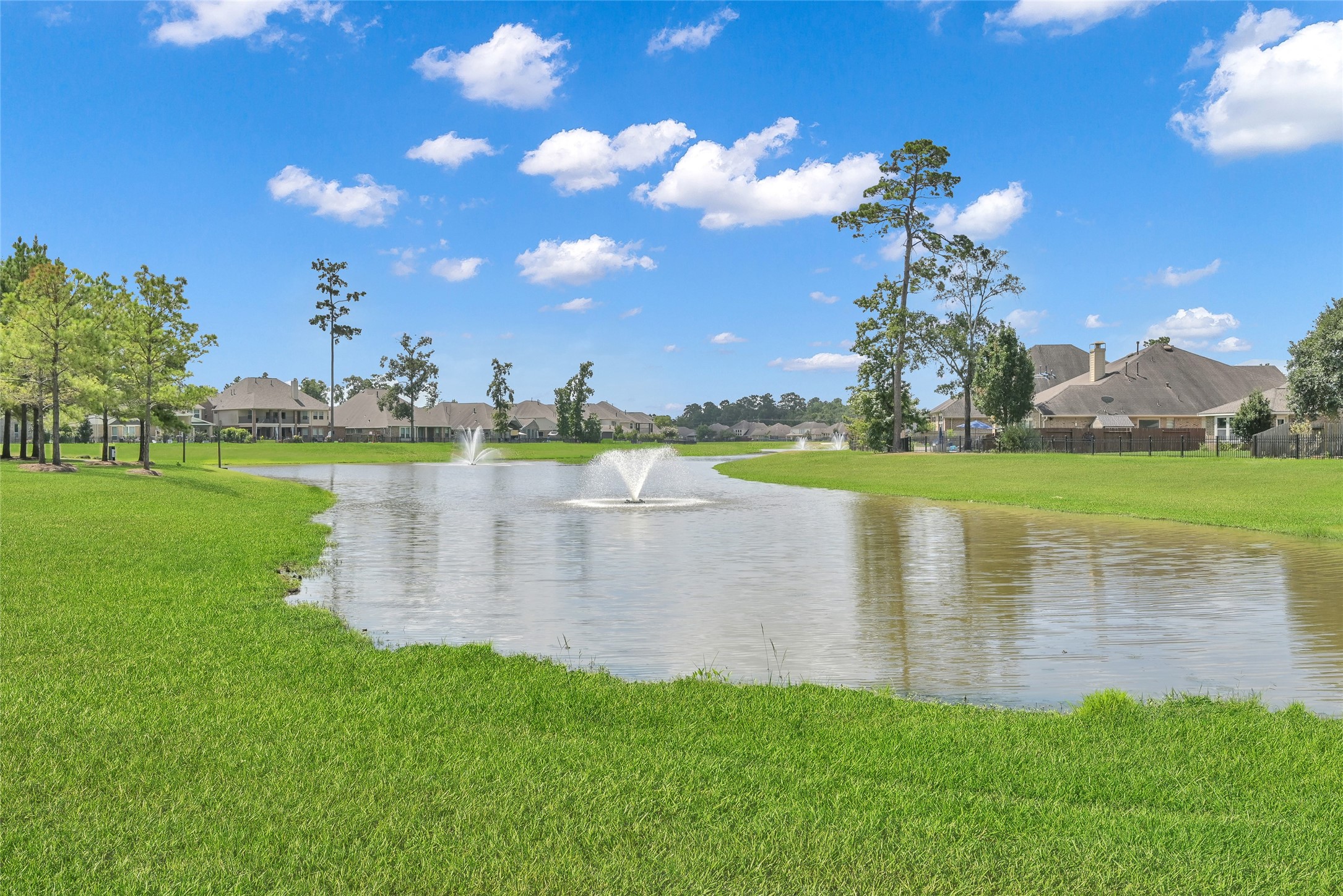 2811 Wilde Redbud Lane Conroe, TX 77385 - Photo 32 of 32 a view of a lake with houses in the background