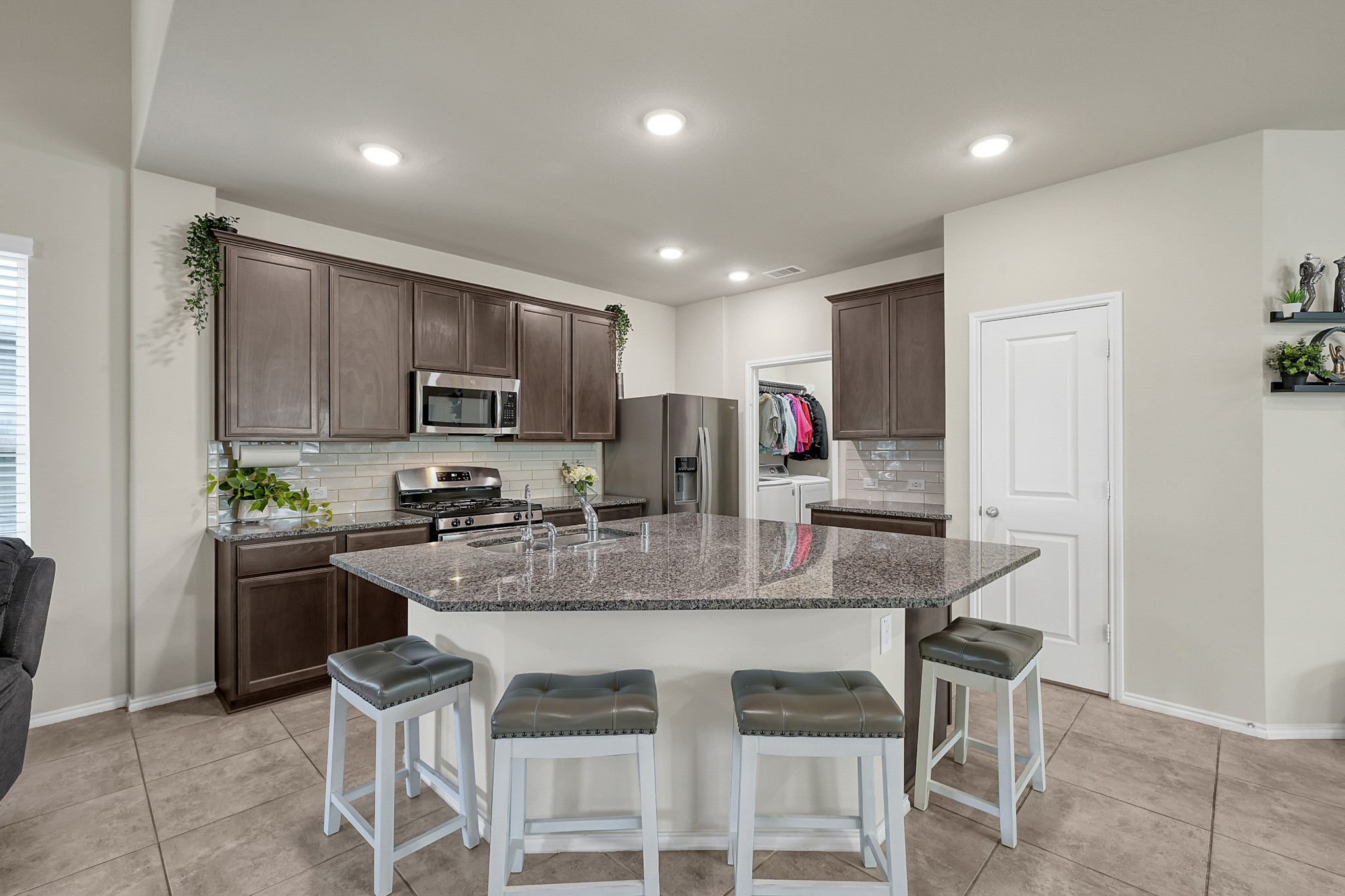 2811 Wilde Redbud Lane Conroe, TX 77385 - Photo 9 of 32 a kitchen with kitchen island granite countertop a table and chairs in it