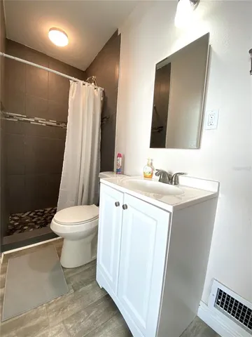 a white toilet sitting next to a shower curtain