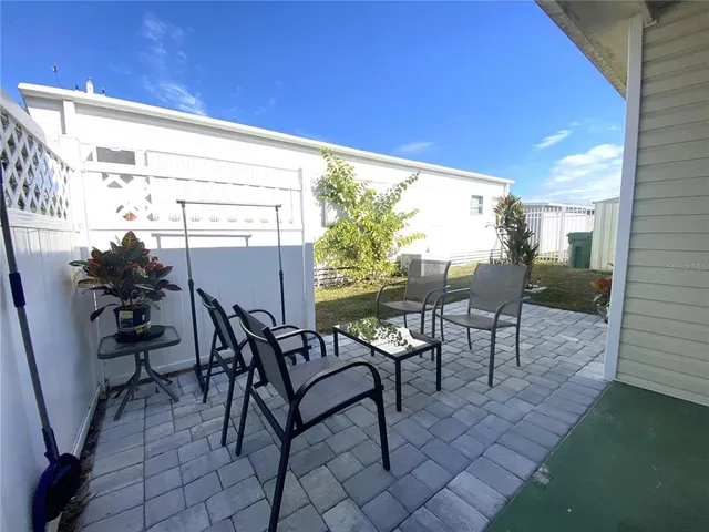 a view of a chairs and table in patio