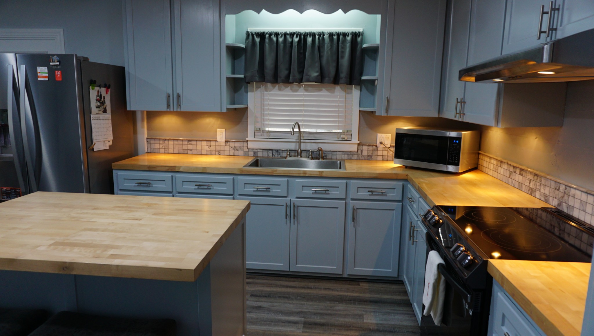 5323 Lanes Ferry Road Newbern, TN 38059 - Photo 11 of 31 a kitchen with stainless steel appliances granite countertop a sink stove and refrigerator