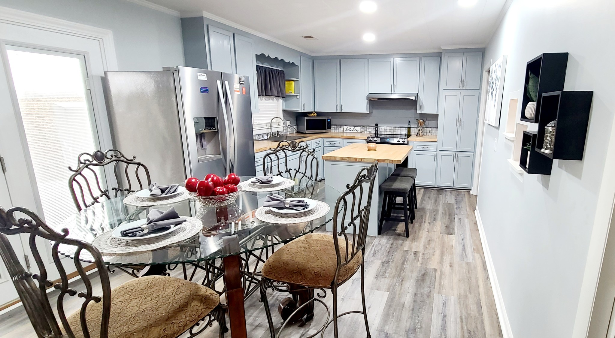 5323 Lanes Ferry Road Newbern, TN 38059 - Photo 15 of 31 a kitchen with stainless steel appliances kitchen island granite countertop a dining table and chairs