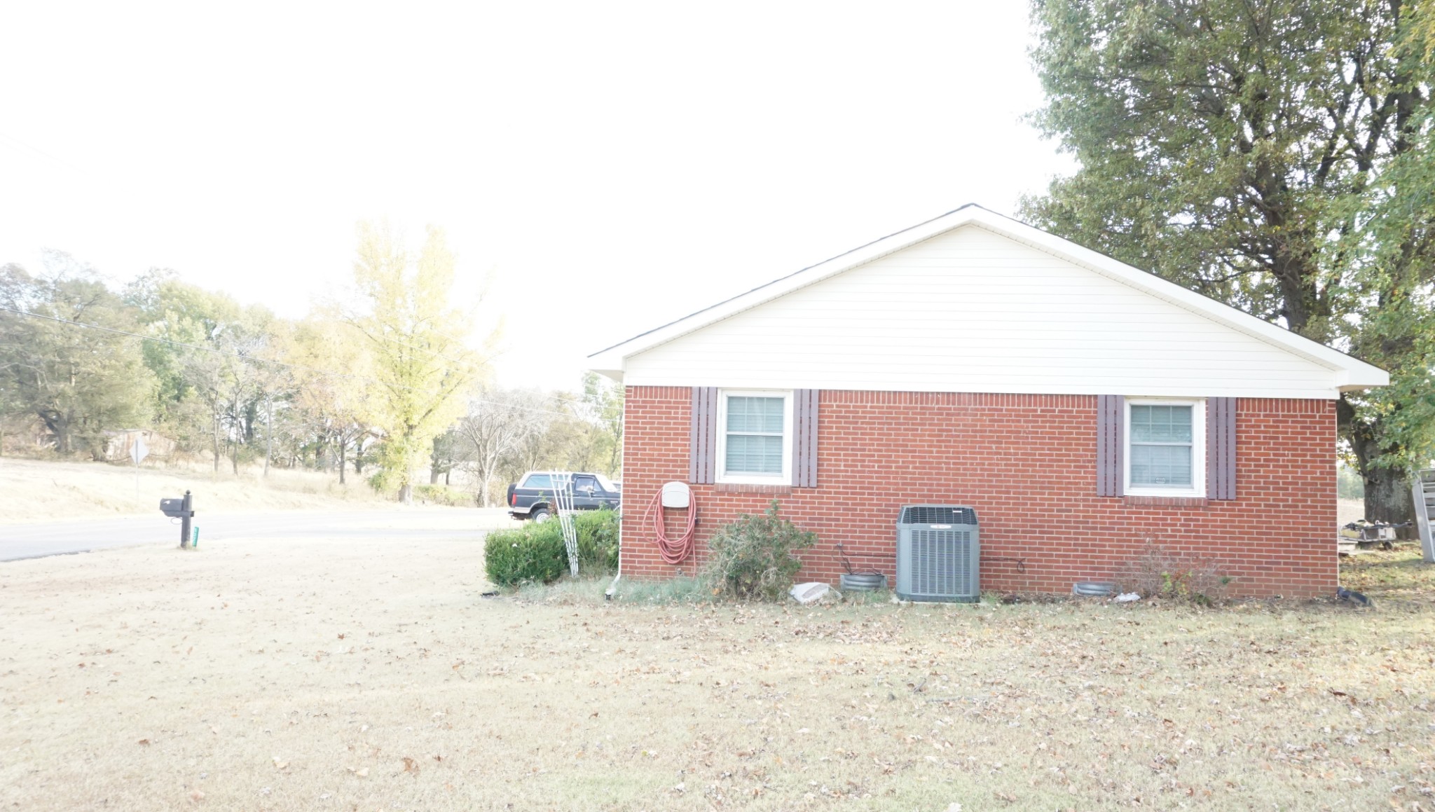 5323 Lanes Ferry Road Newbern, TN 38059 - Photo 31 of 31 a backyard of a house with fire pit and trees