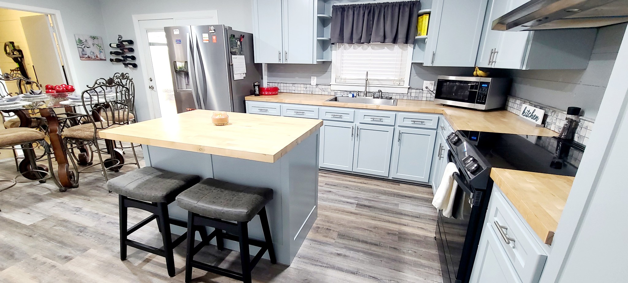 5323 Lanes Ferry Road Newbern, TN 38059 - Photo 10 of 31 a kitchen with a sink a stove and chairs