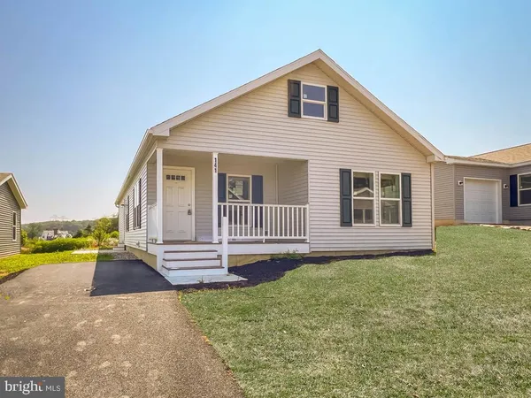 a view of a house with a yard and pathway