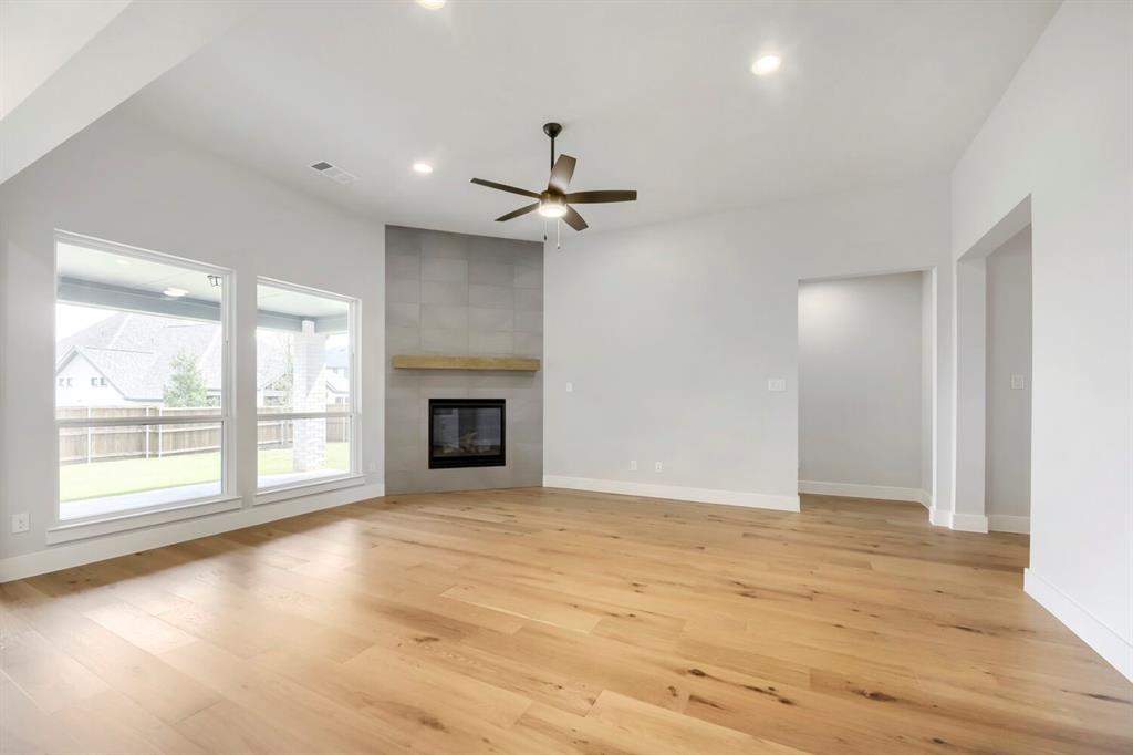 799 Mandrake Road Haslet, TX 76052 - Photo 4 of 27 an empty room with windows and a fireplace