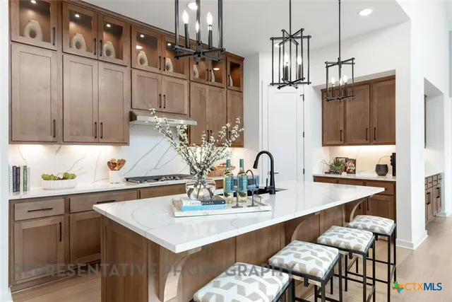 a kitchen with a sink cabinets and window
