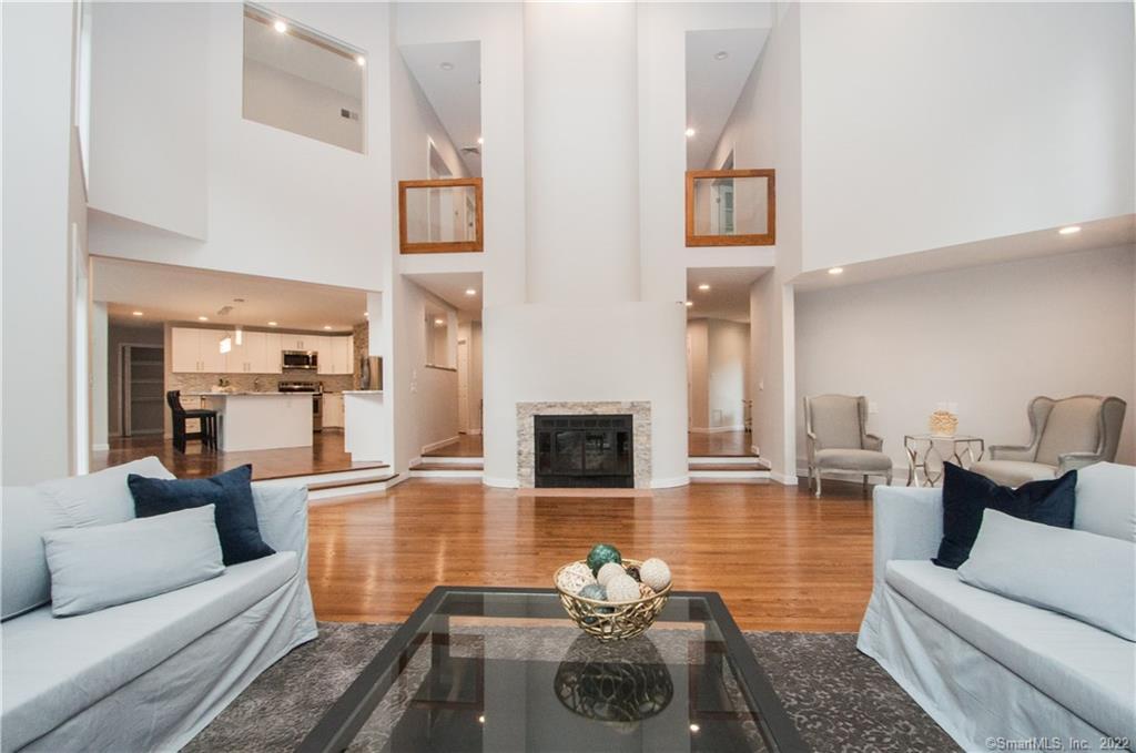 27 Indian Valley Road Weston, CT 06883 - Photo 1 of 1 a living room with furniture and a fireplace