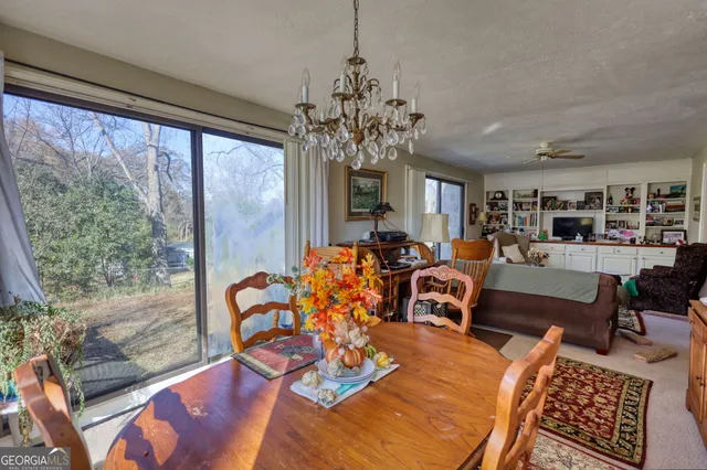 a living room with furniture wooden floor and a large window