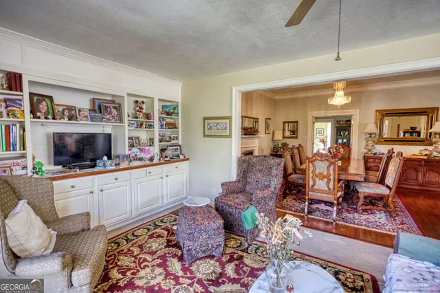 a room with furniture pool table and flat screen tv