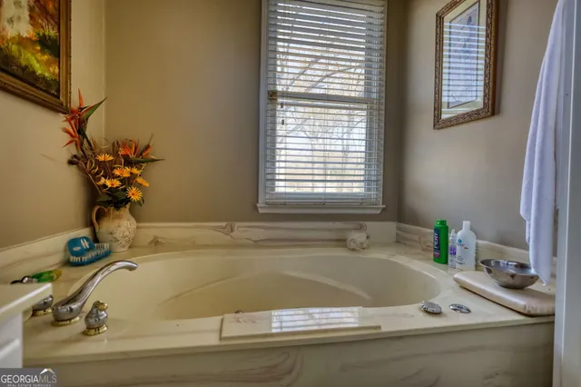 a living room with furniture a fireplace and a large window