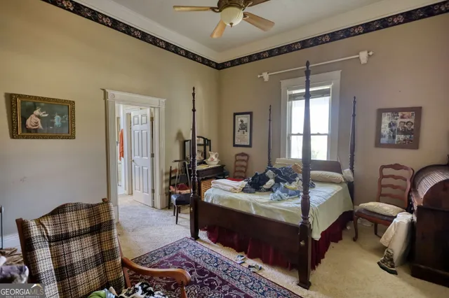 a view of a backyard with a fire pit and a large tree