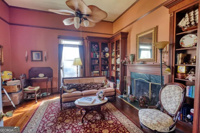 a view of white house with a big yard and large trees