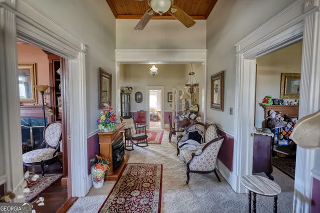 a view of big house with yard and covered with trees