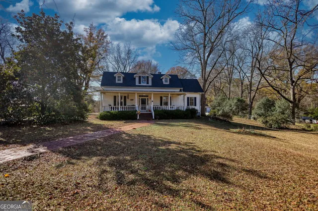 a view of a chairs and table in the balcony