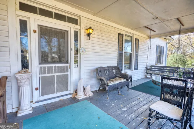 a kitchen with stainless steel appliances granite countertop a refrigerator a sink dishwasher a dining table and chairs with wooden floor