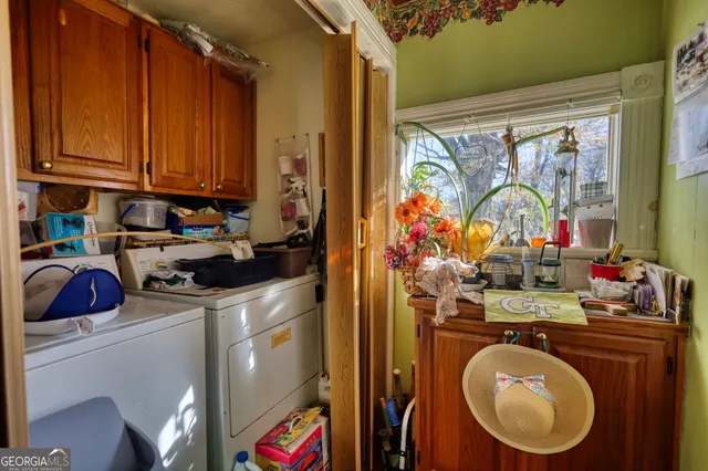 a living room with furniture a bookshelf and a window