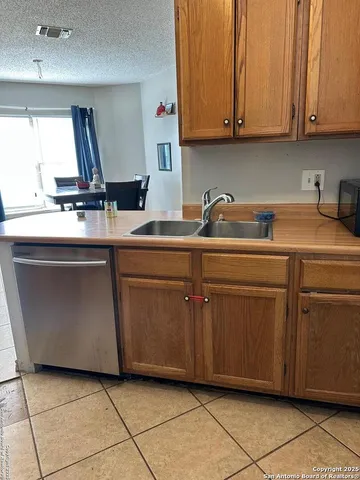 a kitchen with a sink and cabinets