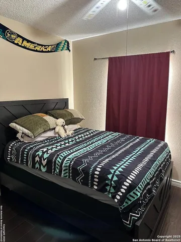 a bedroom with a bed and a mirror