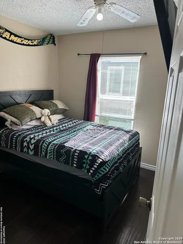 a bedroom with a bed next to a window