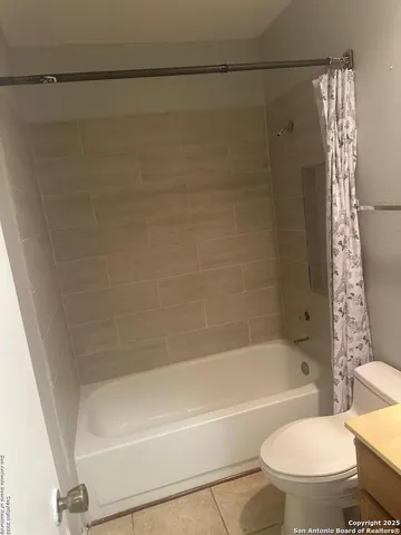 a bathroom with a toilet and a bathtub