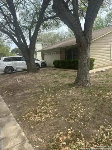 a view of a house with a tree