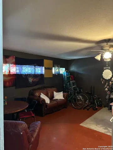 a living room with furniture a lamp and a window