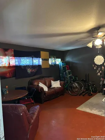 a living room with furniture a lamp and a window