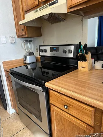 a stove top oven sitting inside of a kitchen