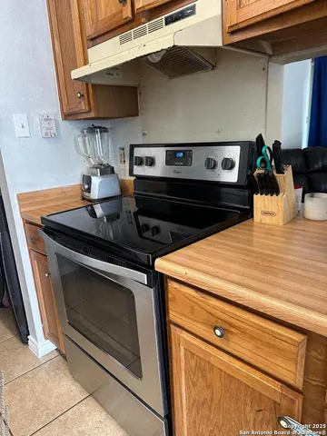a stove top oven sitting inside of a kitchen