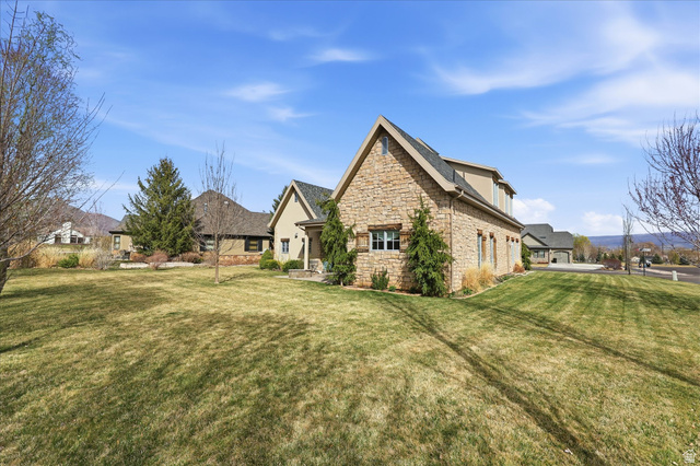 930 Price Farm Court Midway, UT 84049 - Photo 33 of 42 View of property exterior featuring stone siding and a lawn