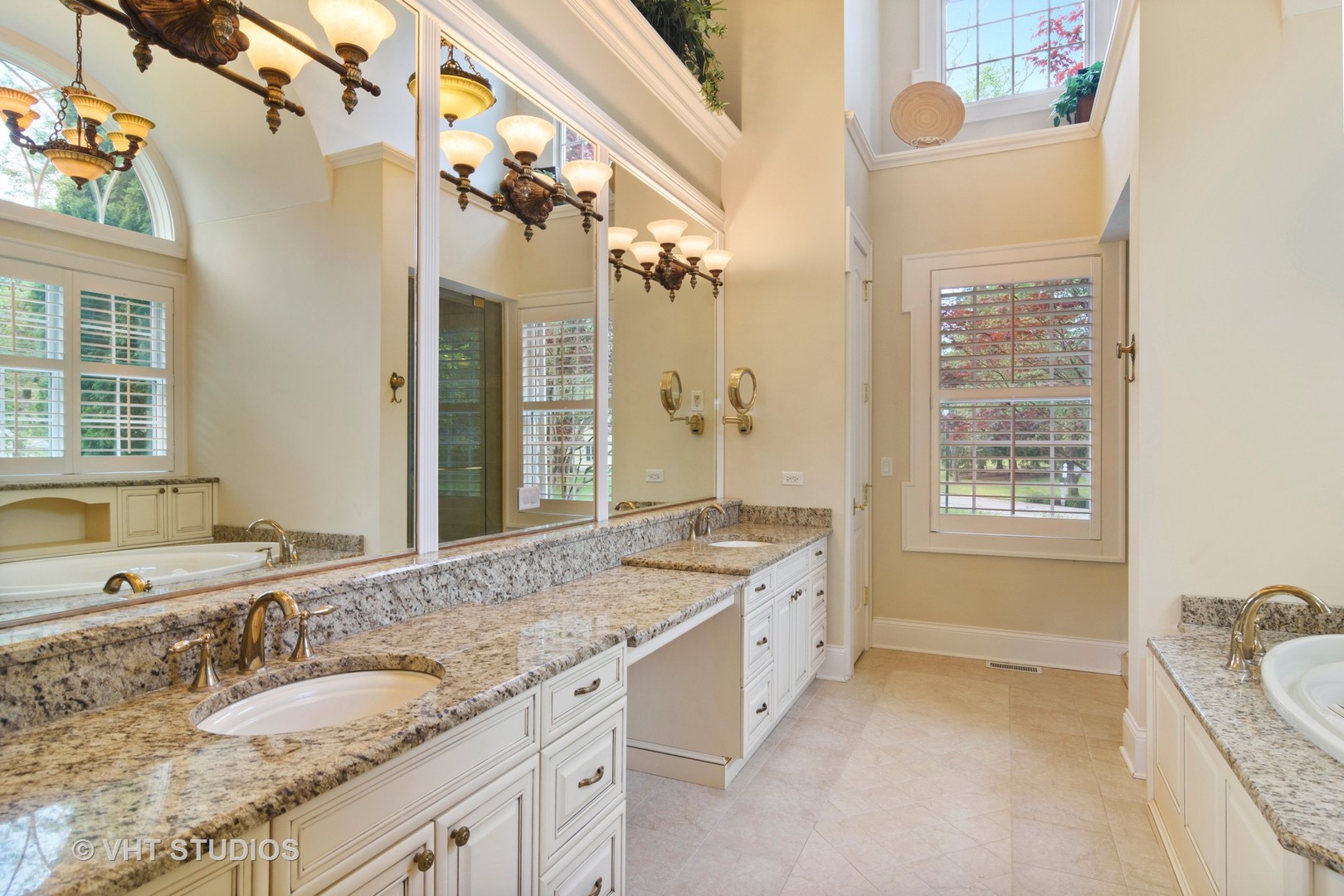 1885 West Durham Drive Inverness, IL 60067 - Photo 12 of 28 a spacious bathroom with a granite countertop sink mirror and a bathtub