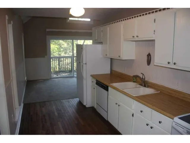 a kitchen with a sink cabinets and a window