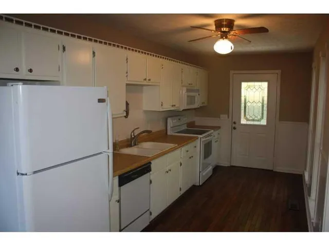 a kitchen with a sink appliances and cabinets