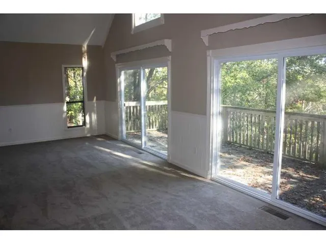 a view of empty room with floor to ceiling windows