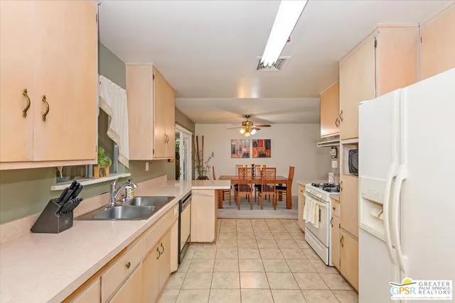 a kitchen with cabinets and chairs