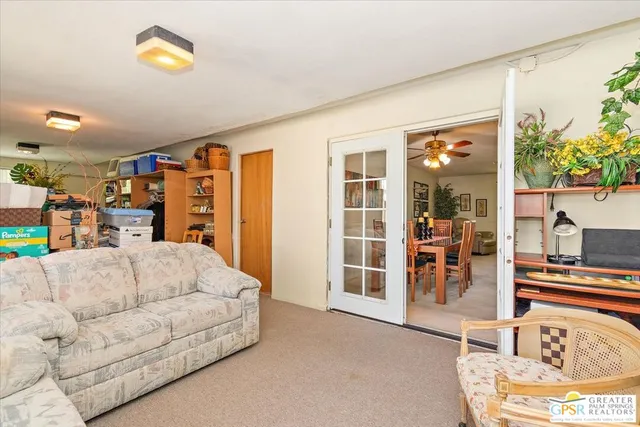a living room with furniture and a potted plant