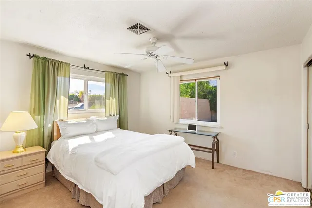 a bedroom with a bed window and table