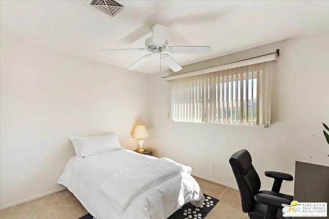 a bedroom with a bed and a chair