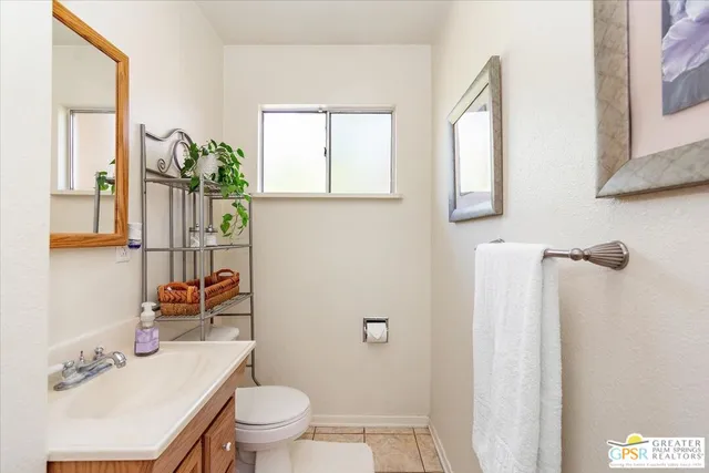 a bathroom with a sink toilet and mirror