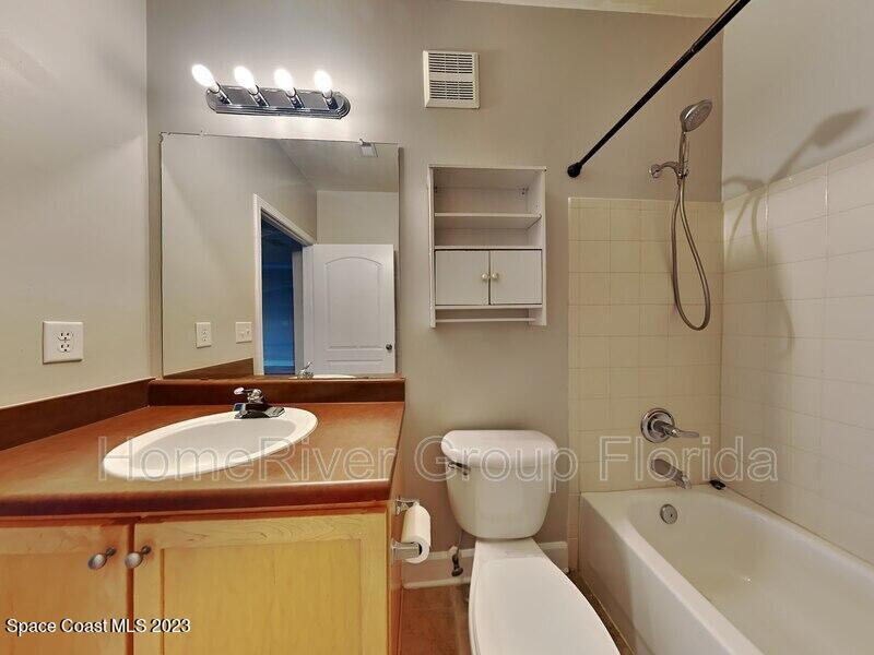 6450 Borasco Drive, Unit 3703 Melbourne, FL 32940 - Photo 11 of 13 a bathroom with a sink and a mirror