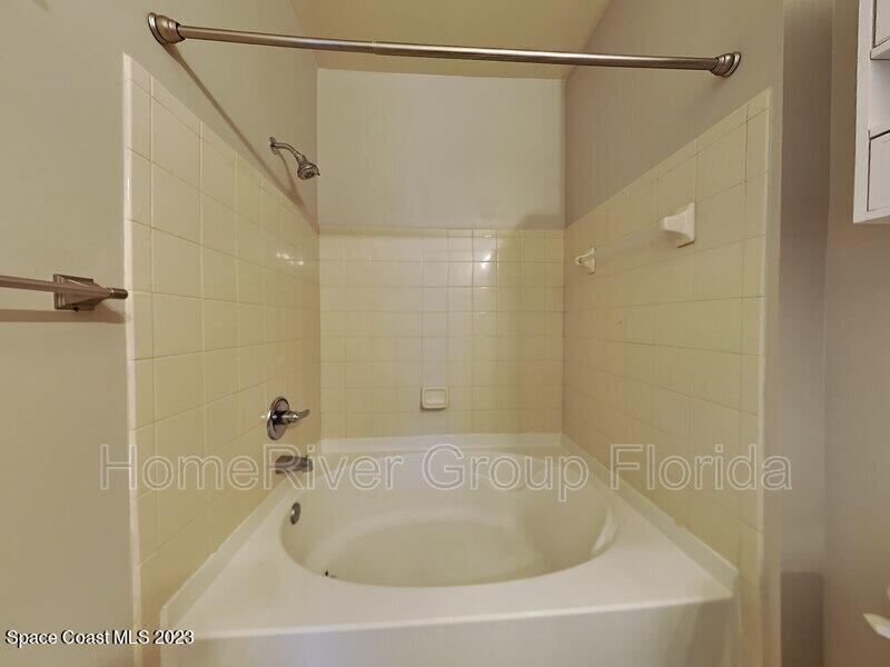 6450 Borasco Drive, Unit 3703 Melbourne, FL 32940 - Photo 4 of 13 a bathroom with a shower and a shower