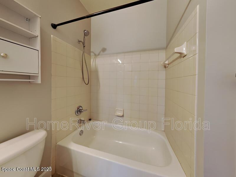 6450 Borasco Drive, Unit 3703 Melbourne, FL 32940 - Photo 7 of 13 a bathroom with a bathtub and a shower