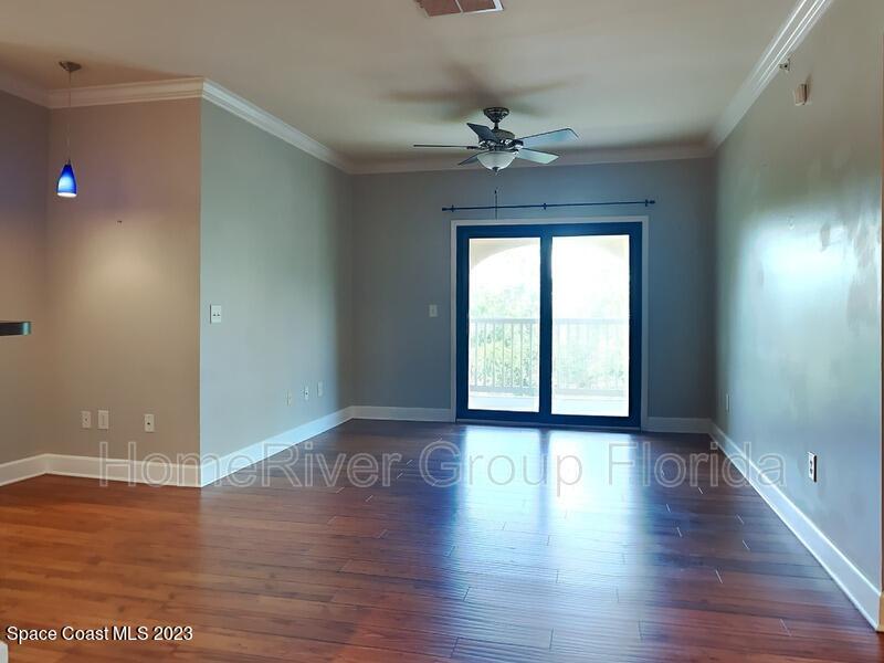 6450 Borasco Drive, Unit 3703 Melbourne, FL 32940 - Photo 8 of 13 wooden floor in an empty room with a window