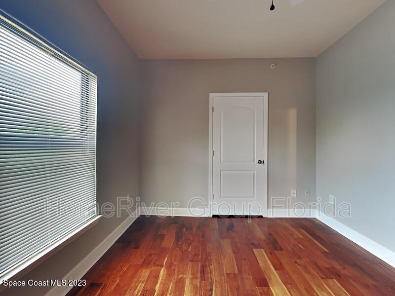 6450 Borasco Drive, Unit 3703 Melbourne, FL 32940 - Photo 10 of 13 a view of an empty room with wooden floor and a window
