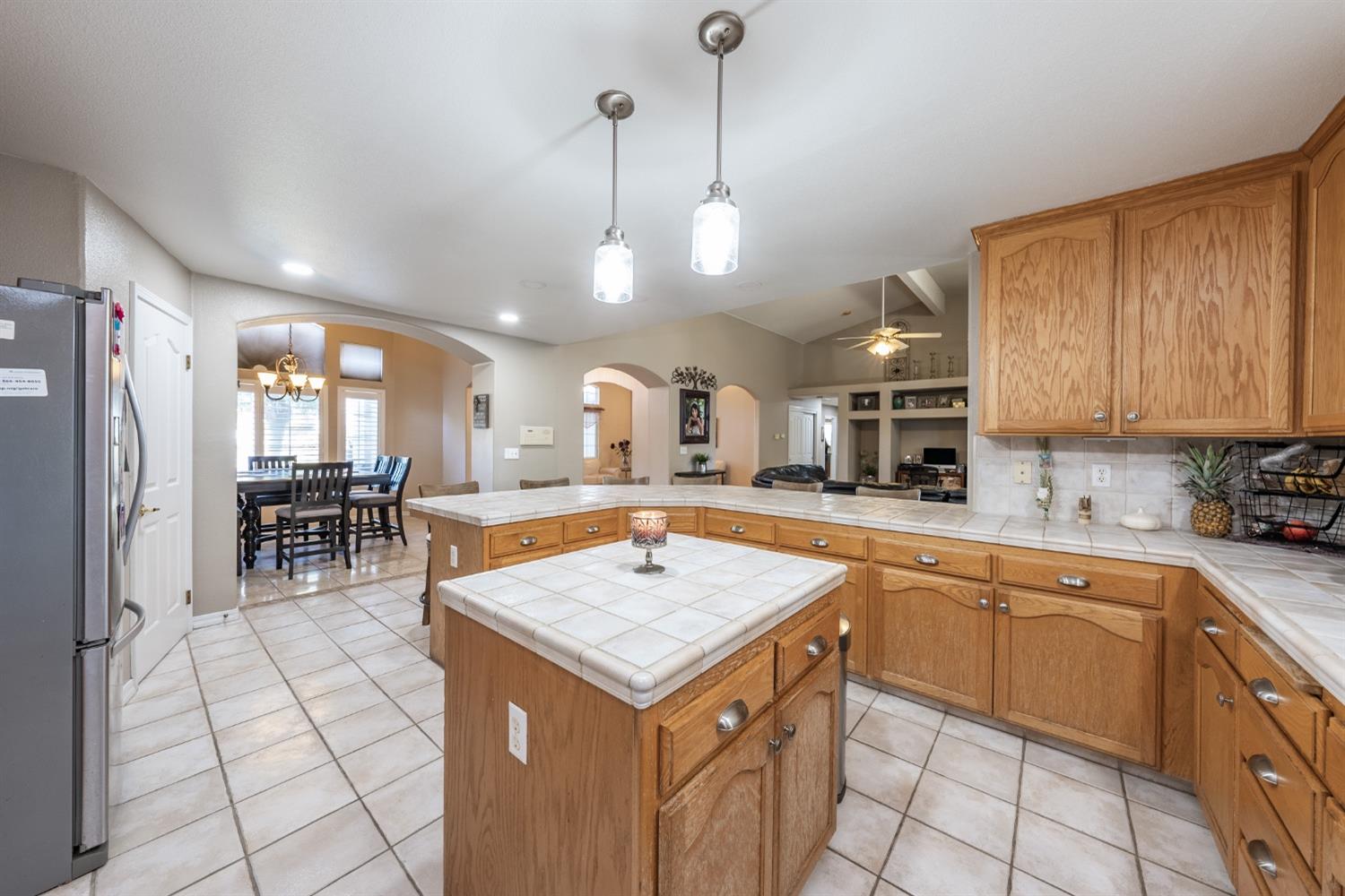 915 Trabon Way Madera, CA 93637 - Photo 14 of 33 a kitchen with a table chairs refrigerator and microwave