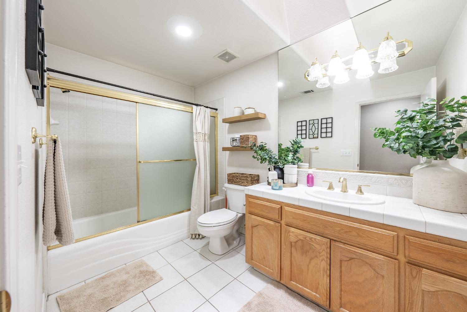 915 Trabon Way Madera, CA 93637 - Photo 17 of 33 a bathroom with a sink a toilet and shower