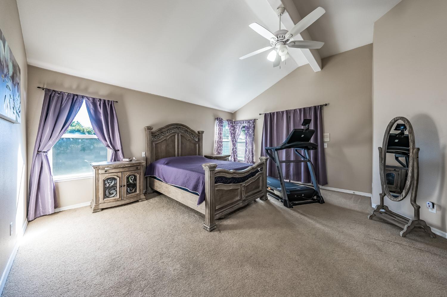 915 Trabon Way Madera, CA 93637 - Photo 18 of 33 a bedroom with bed and a chandelier