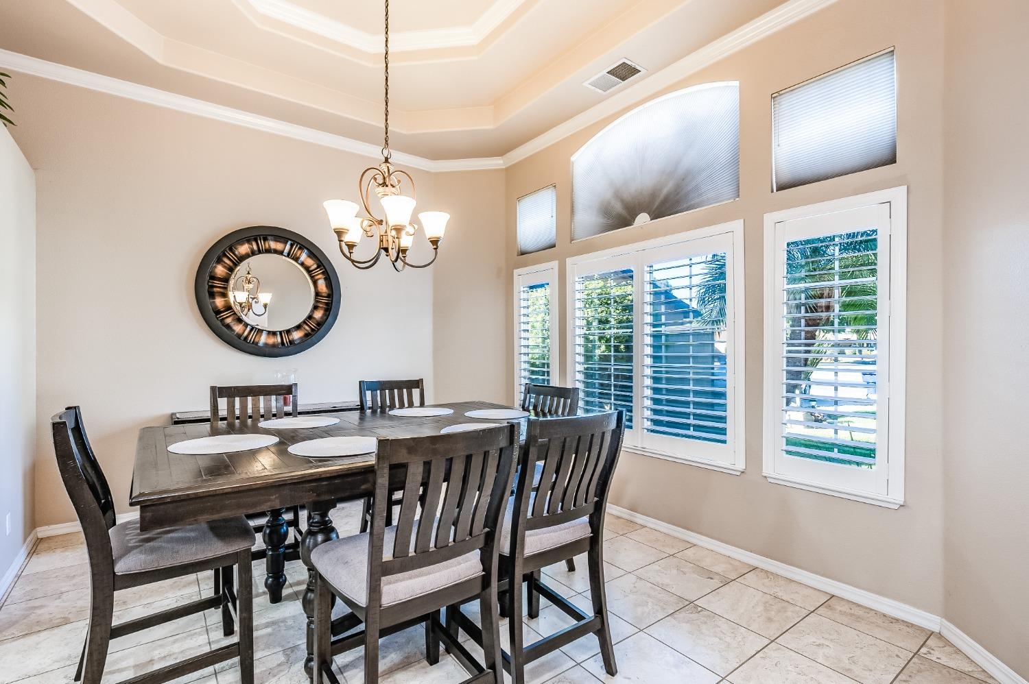 915 Trabon Way Madera, CA 93637 - Photo 5 of 33 a dining room with chandelier and wooden floor