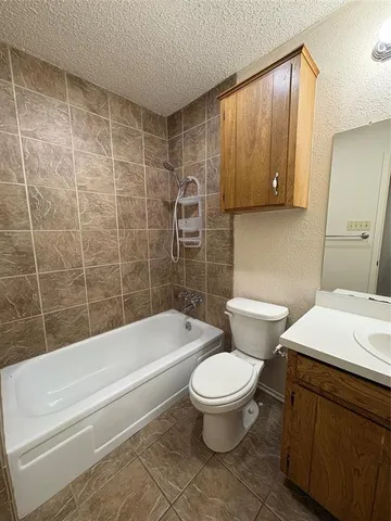 a bathroom with a toilet a sink and bathtub